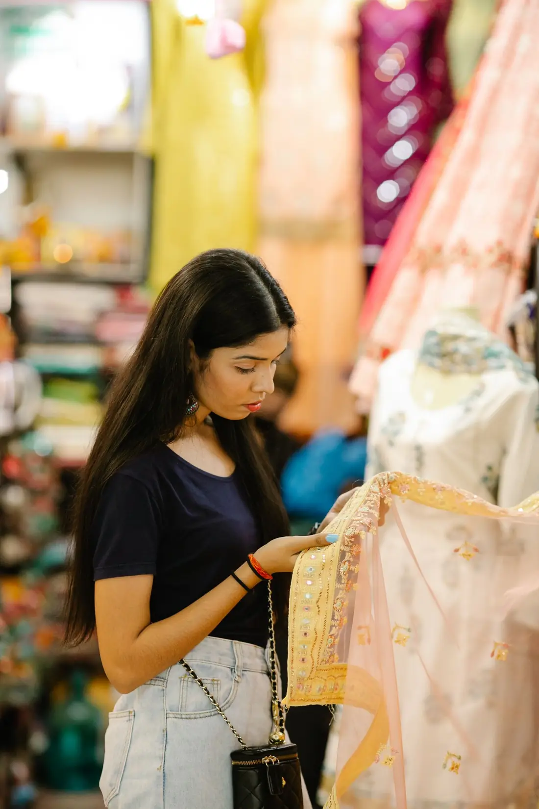A customer choosing fabric in an Indian clothing shop